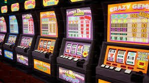 Mobile phone showing game slot platform interface on a Philippine street